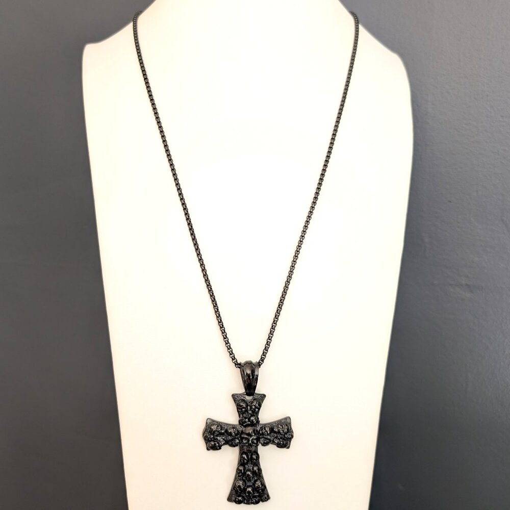 Black metal cross with skulls necklace